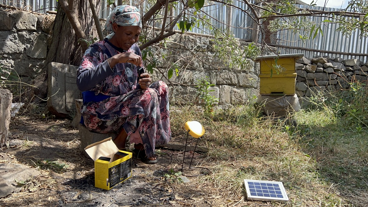 Community member using solar lantern